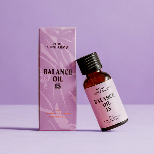 cbd oil bottle concept packaging leaning on a box that reads "Balance Oil 15" on purple background